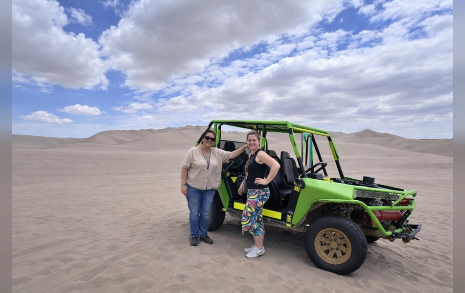 Tourists posing next to a dune buggy during a desert adventure in Paracas, Peru | Inca Culture Travel