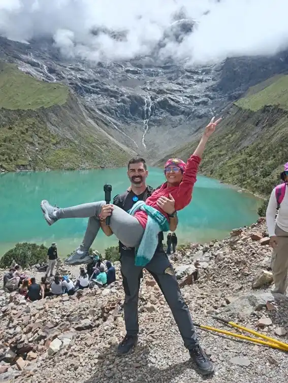 A couple of hikers walking along the Humantay Lagoon trail with panoramic views of the Andes | Inca Culture Travel